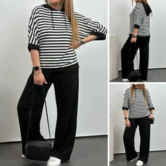 Costum de damă cu top cu dungi și pantaloni de culoare uni